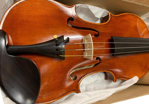 Left-handed violin in a shipping box
