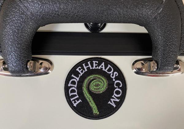 White mandolin case with fiddleheads embroidered patch