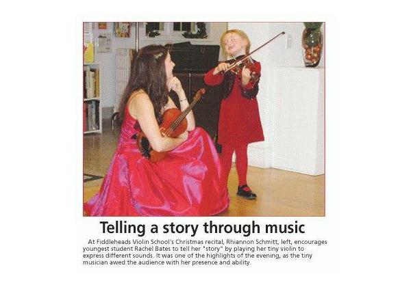 Rhiannon, kneeling in a formal red dress, listens as little Rachel tells a story  while playing violin