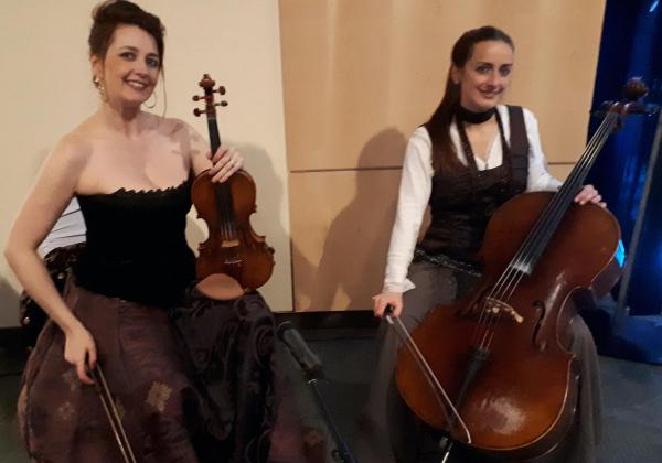 Rhiannon and a cellist dressed as female pirates with their instruments