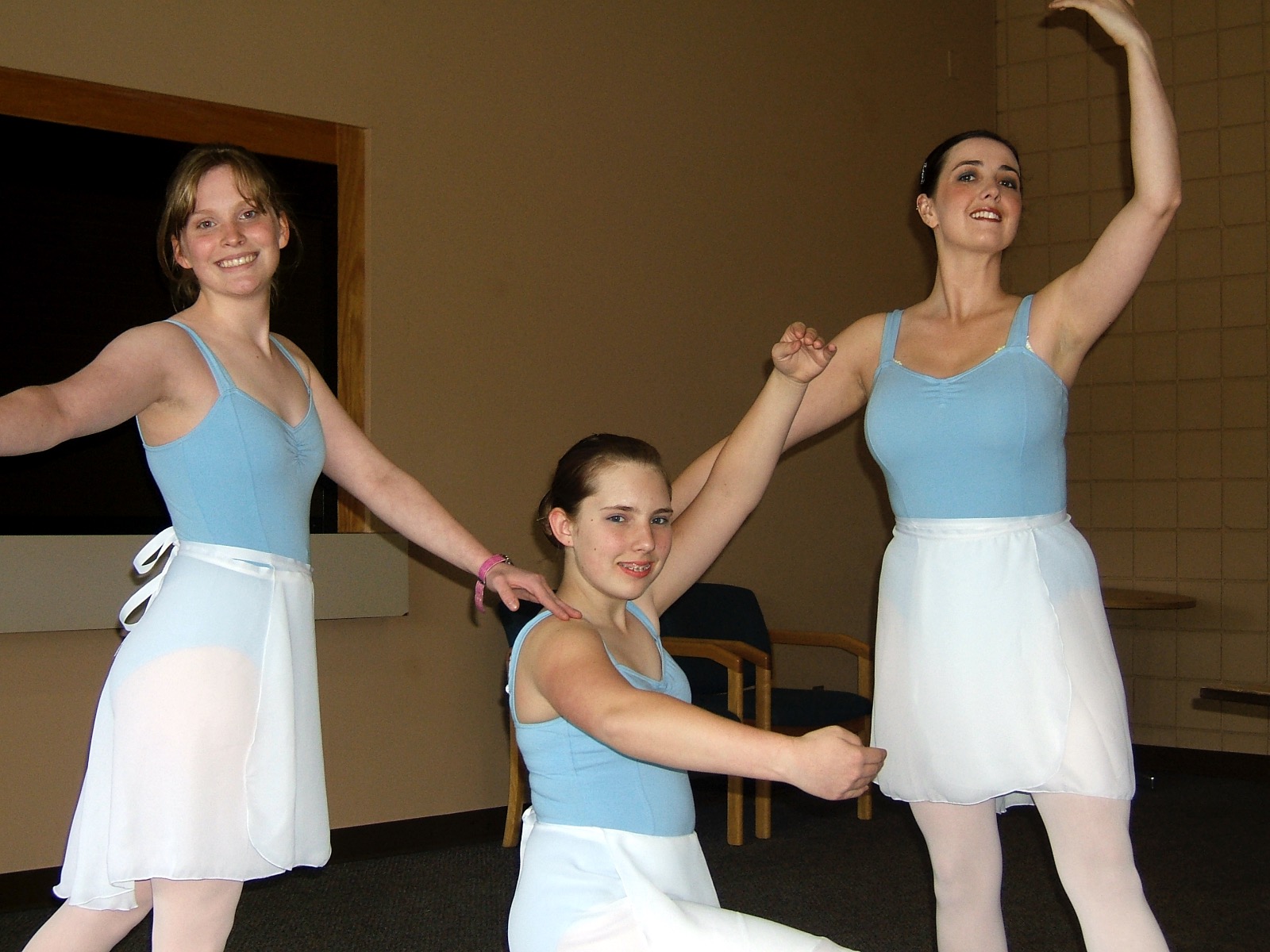 Rhiannon in powder blue ballet attire posing with two similarly dressed teens