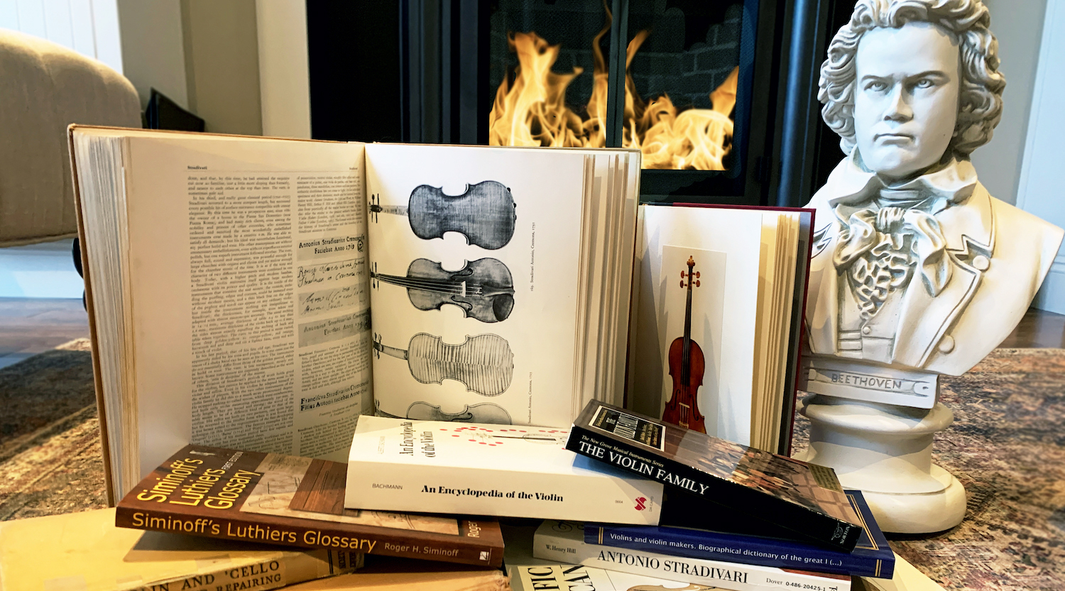 stack of books and Beethoven bust in front of a fireplace