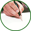 circular image with green border - hand holding a pen and signing a paper