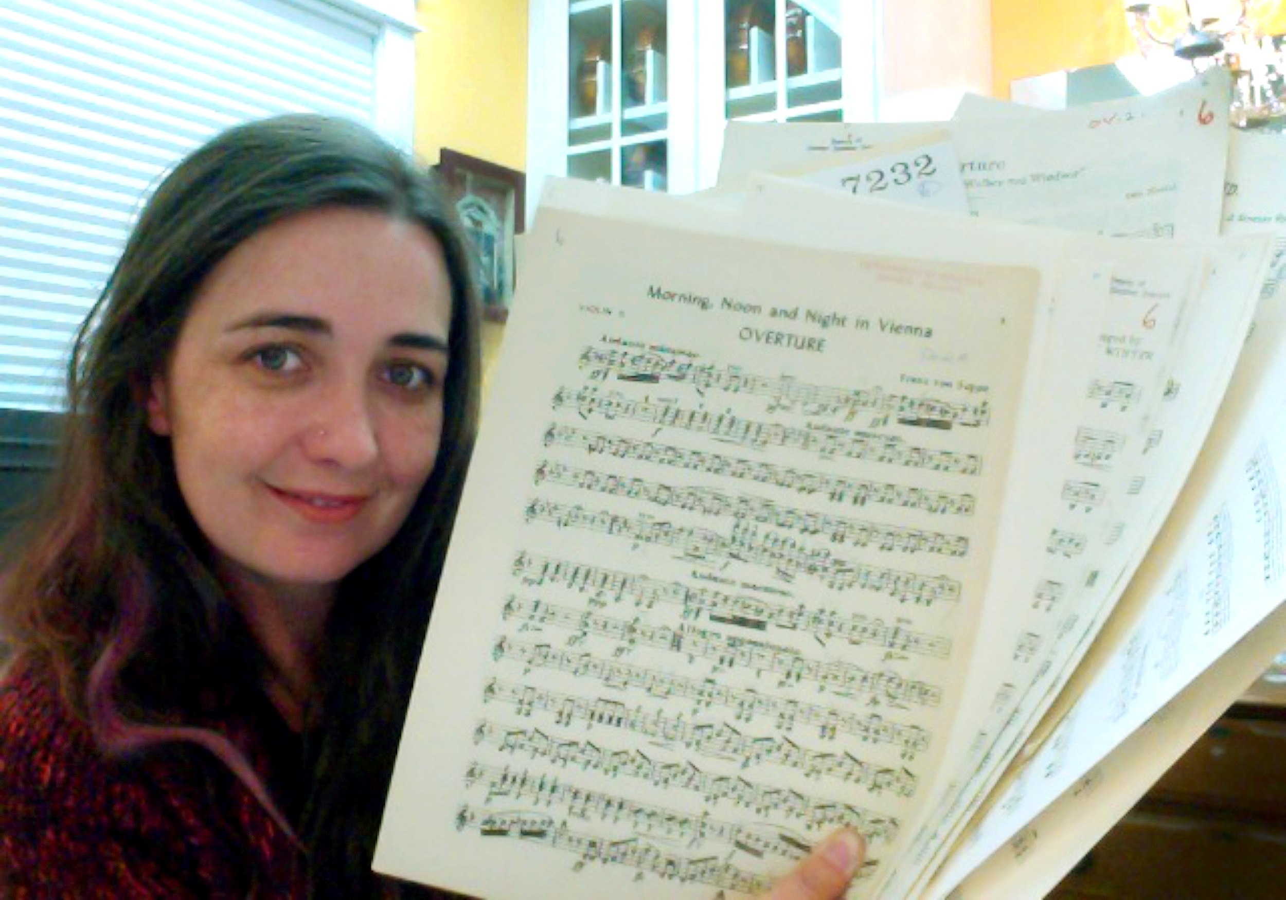 Rhiannon holding sheet music from the mail