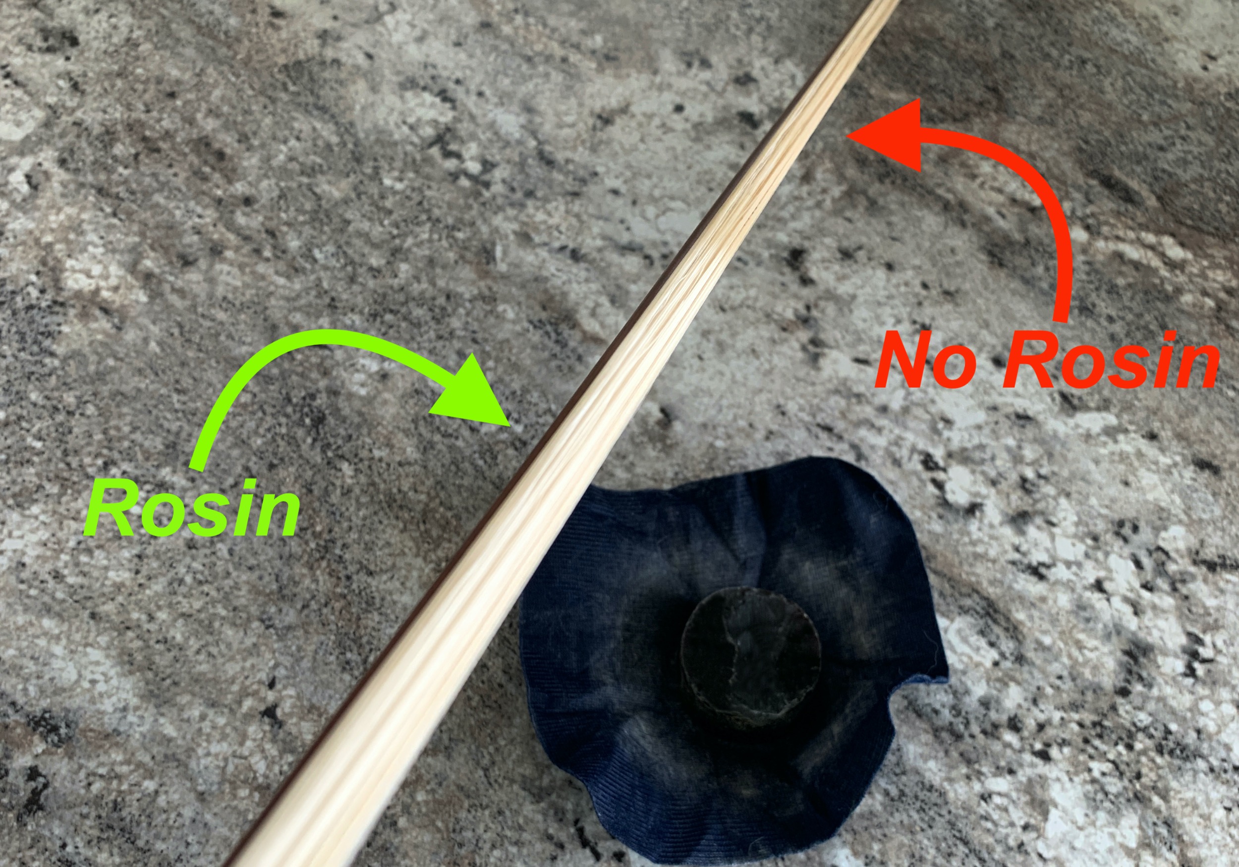 Bow hairs over rosin with part not yet rosined
