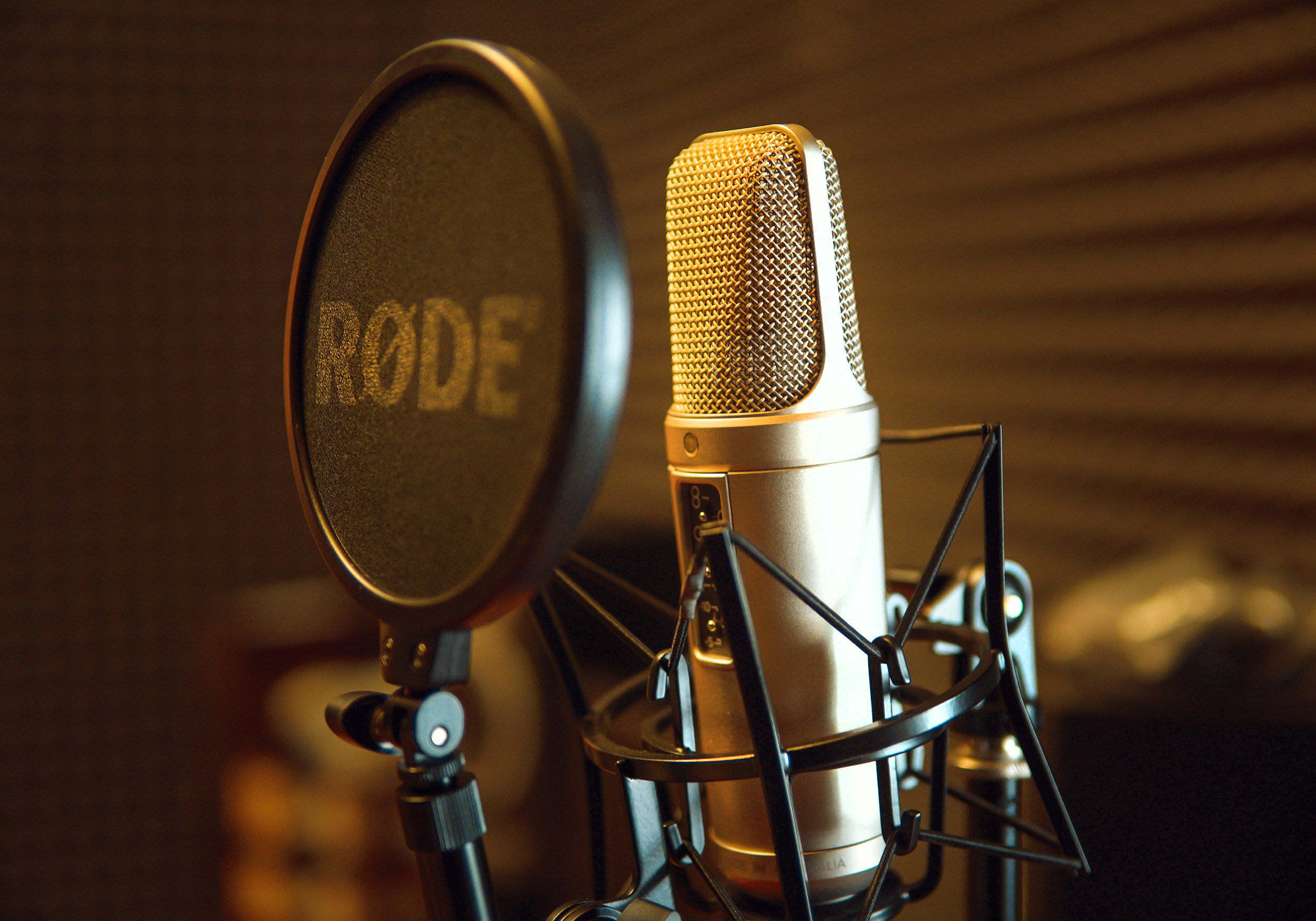 Microphone and pop filter in a studio with moody lighting
