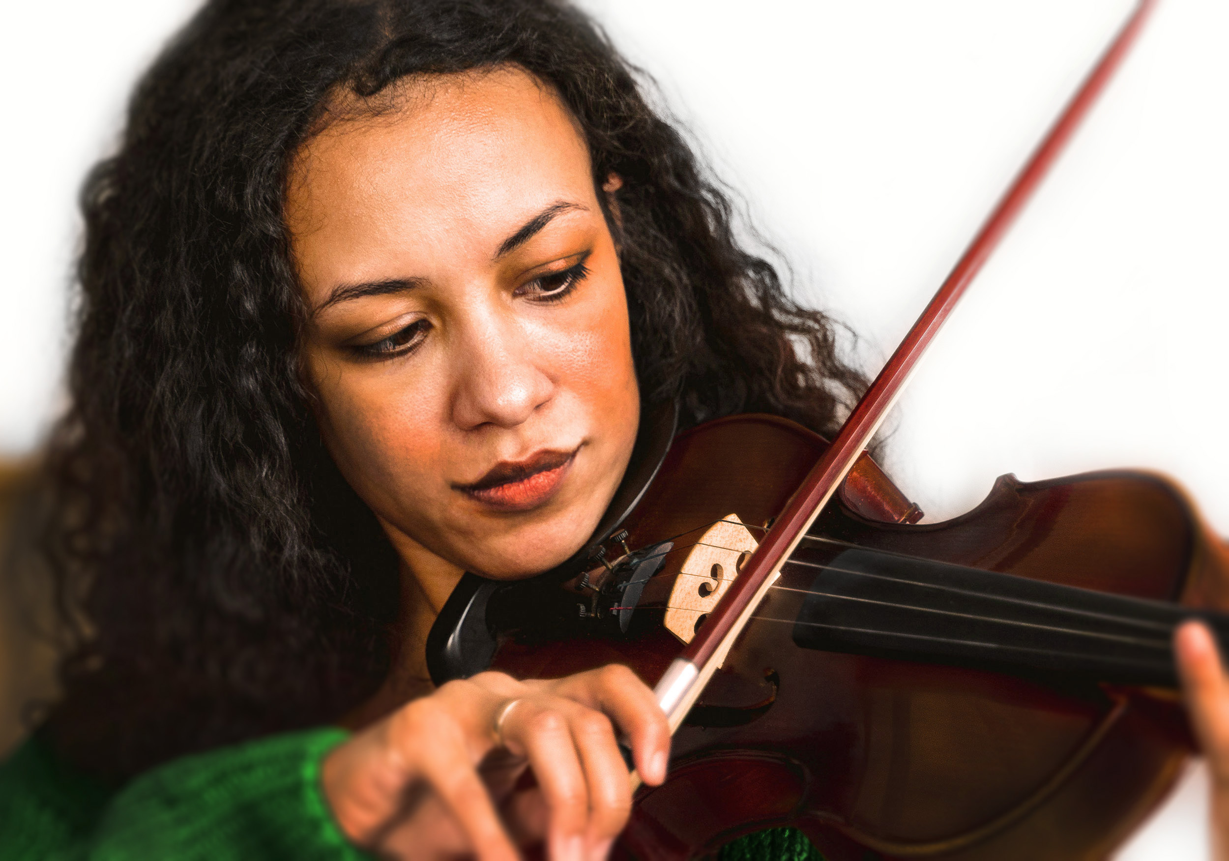 beautiful black woman with beautiful curly long hair and a green sweater smirking while playing a violin