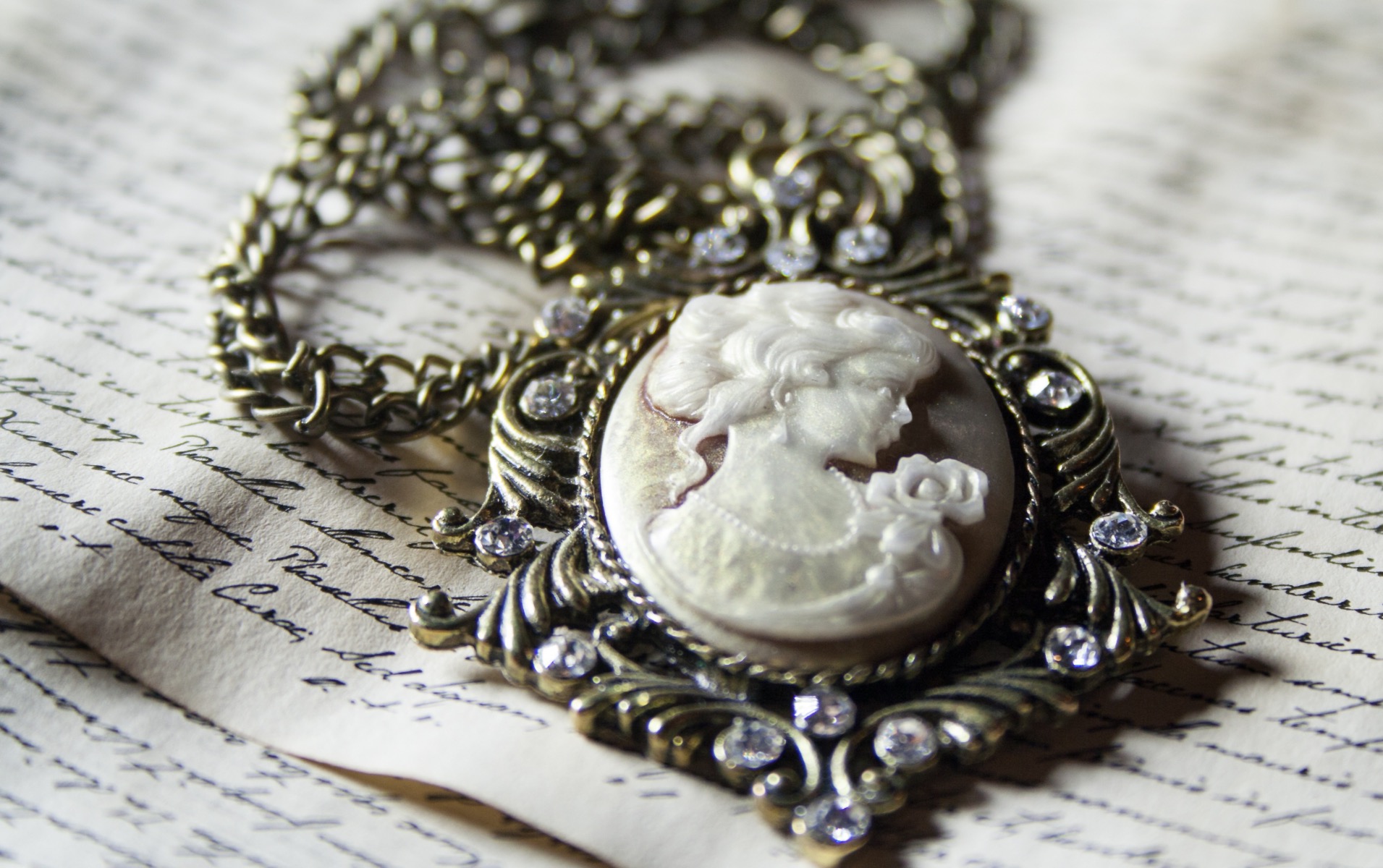 Antique cameo necklace over handwritten letters