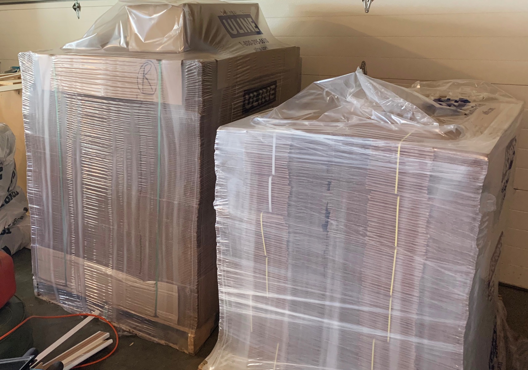 Two large pallets of folded shipping boxes