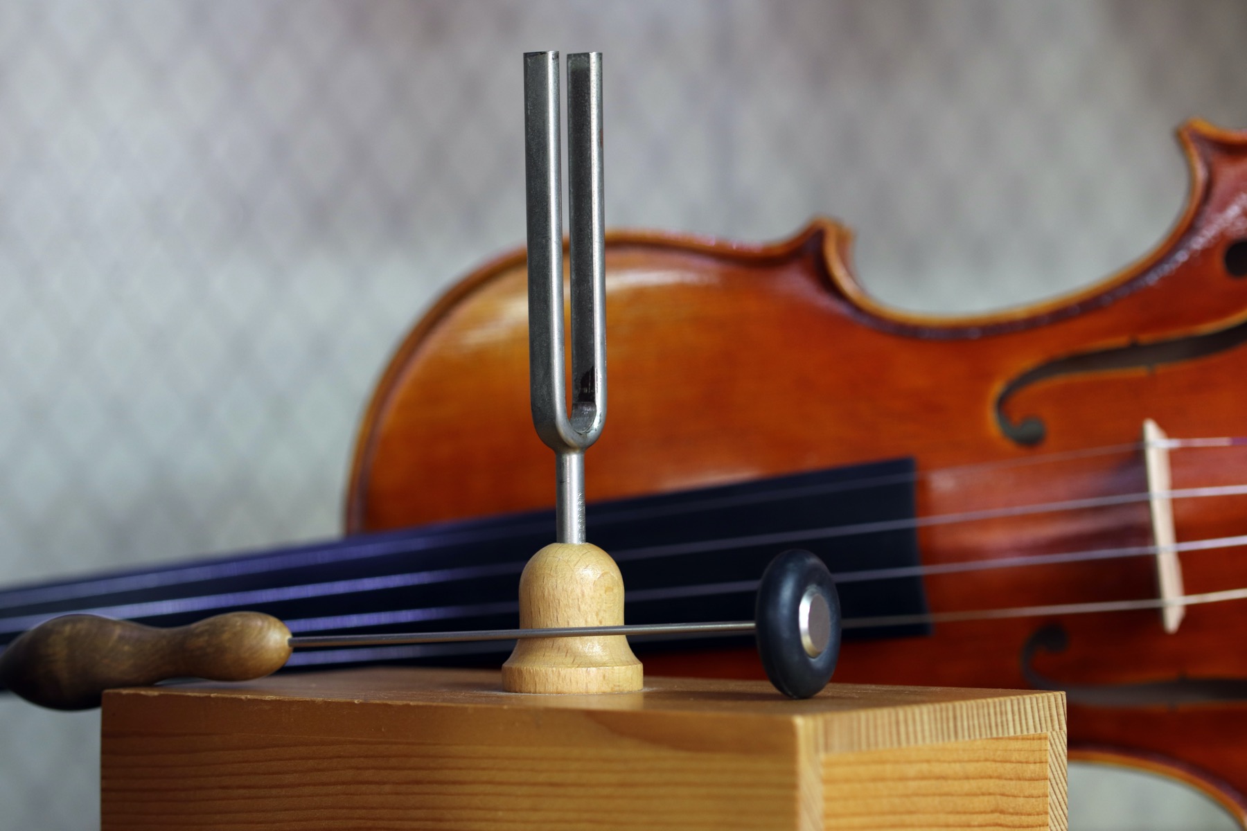 Violin beside a tuning fork