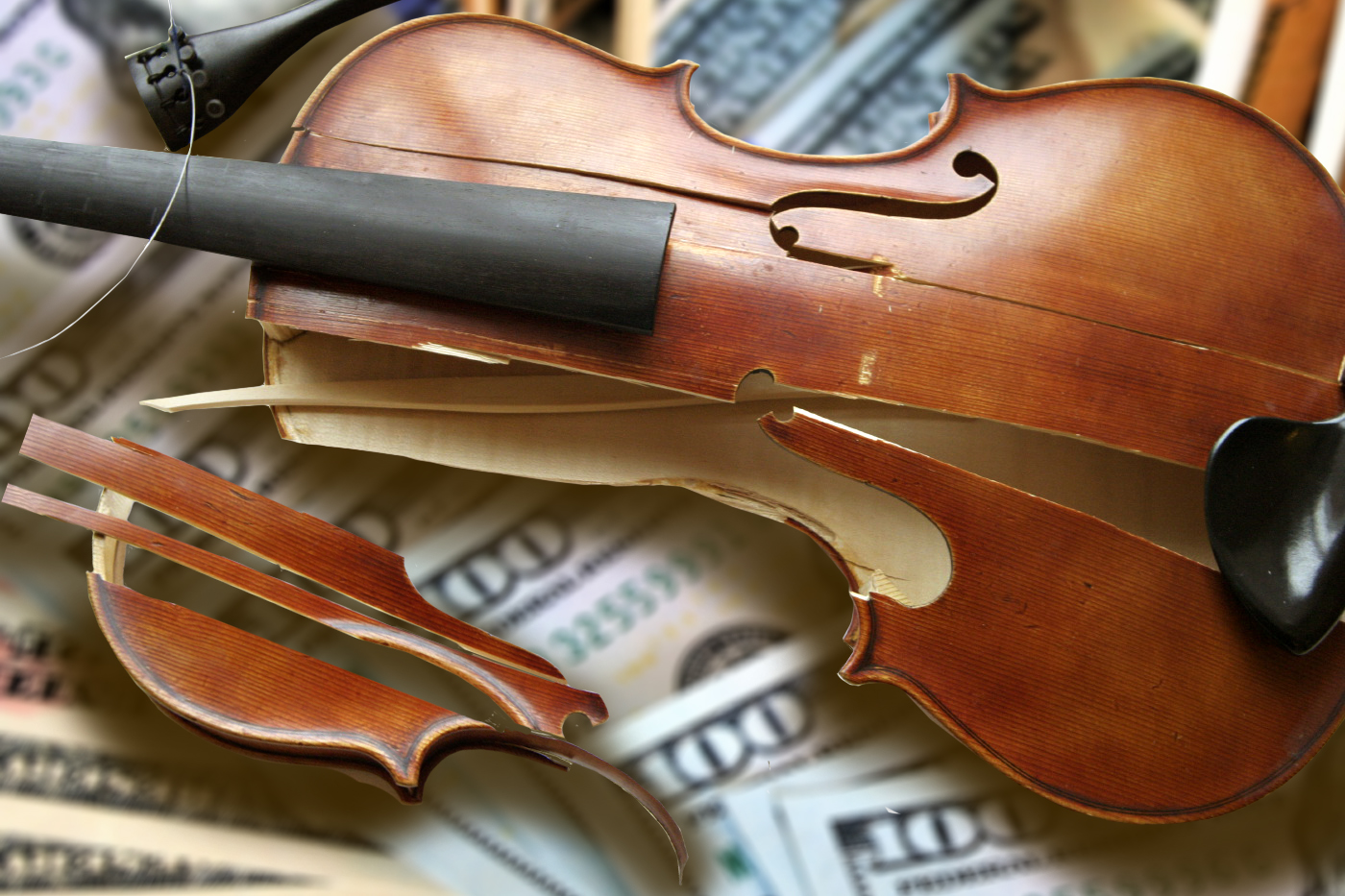 broken violin over hundred dollar bills
