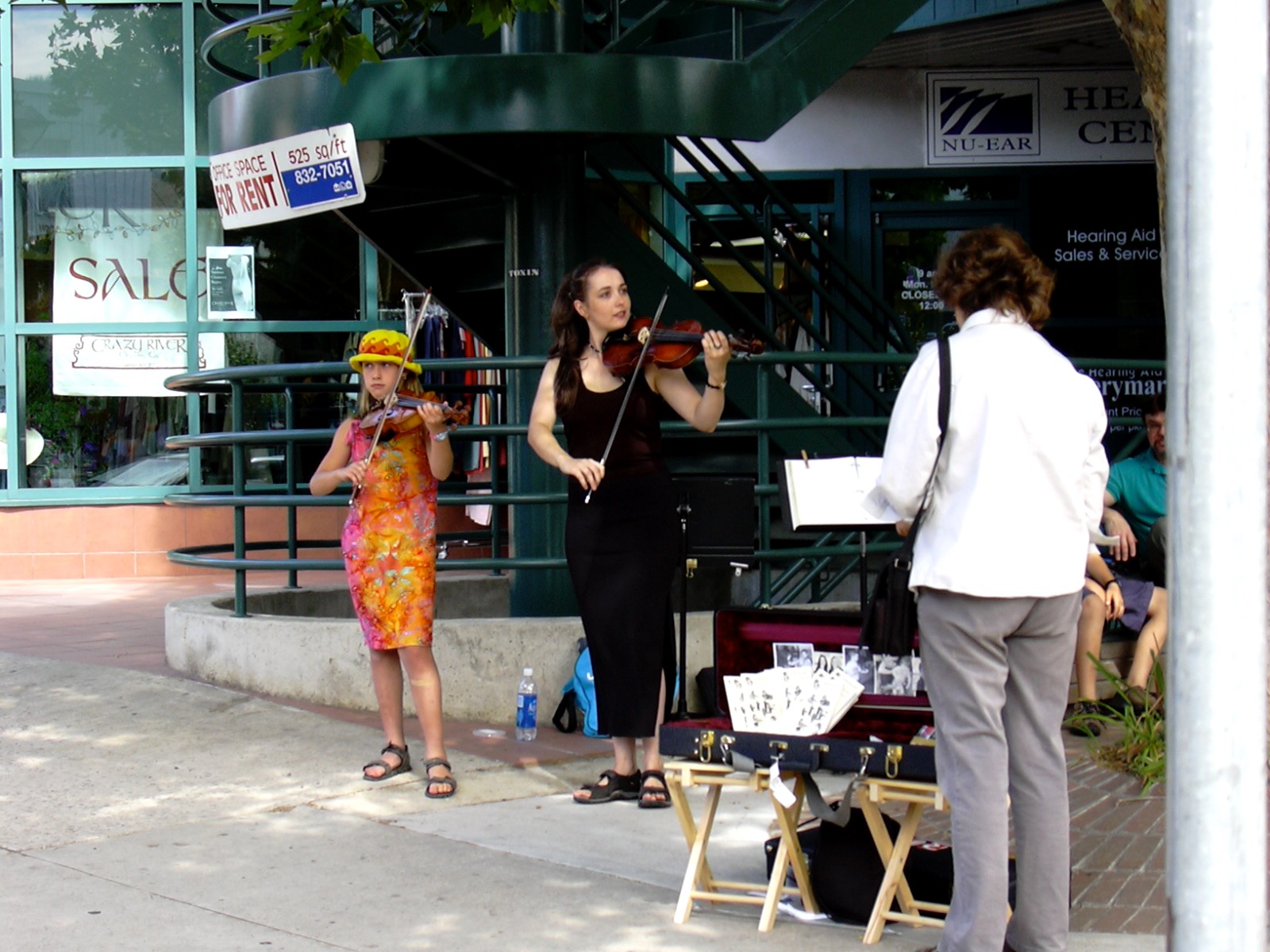 Rhiannon busks with a young student 2003
